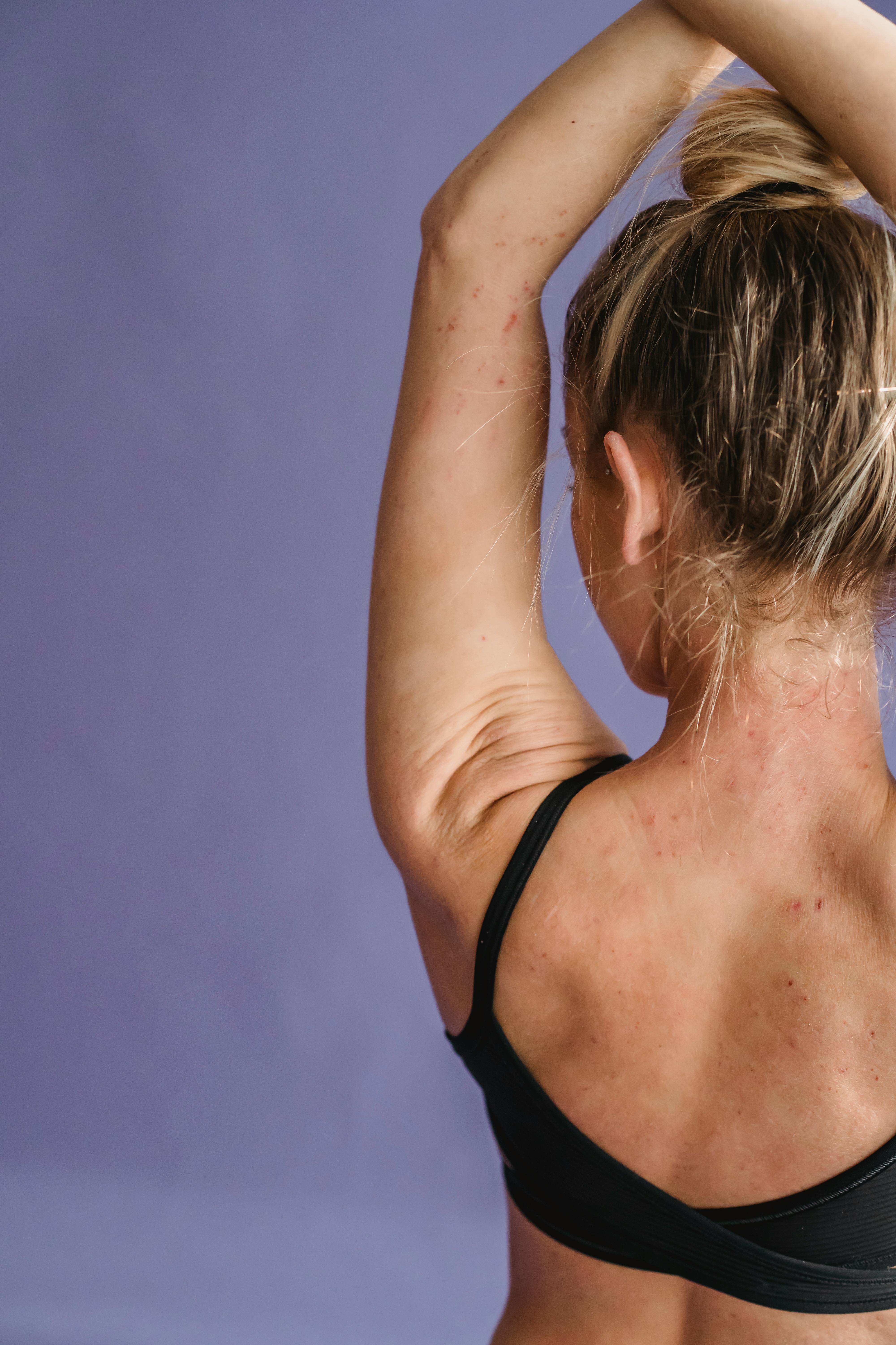 woman in sportswear crossing hands above head