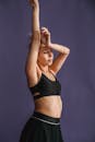 Peaceful female raising arms in studio