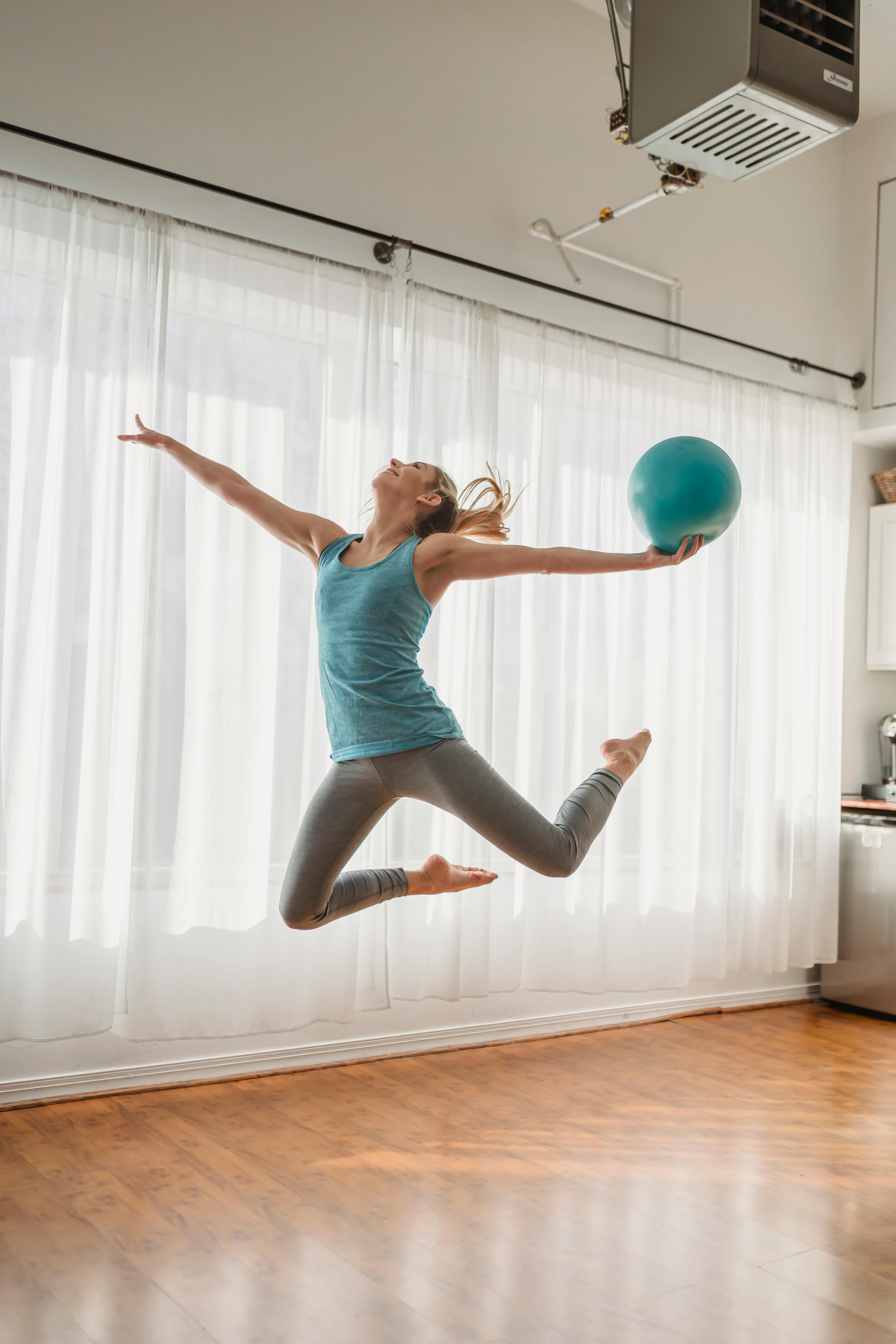 Energetic Woman Jumping With Fit Ball · Free Stock Photo