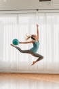 Fit woman doing gymnastic exercise with fit ball