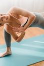 Cheerful woman doing Revolved crescent lunge asana