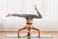 Strong woman doing Upavishtha Konasana Shirshasana posture