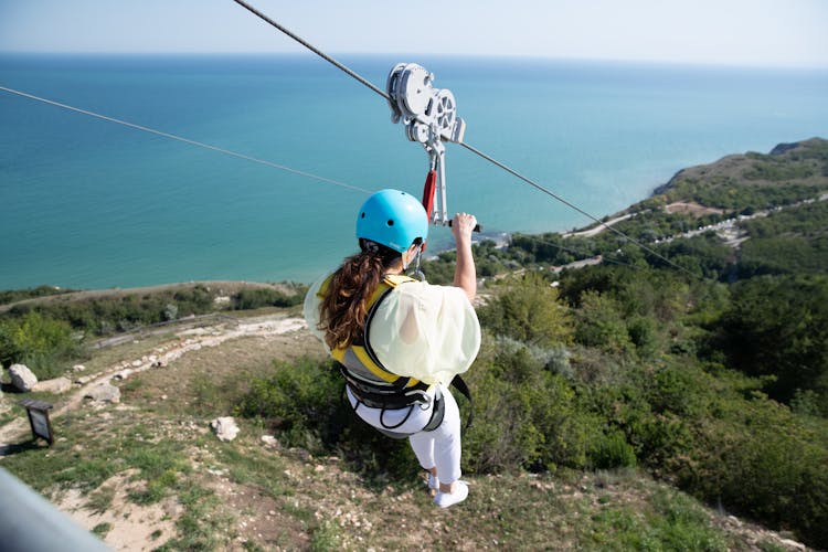 A Woman Riding A Zipline