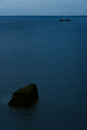 Black Rock Formation on Blue Sea Water