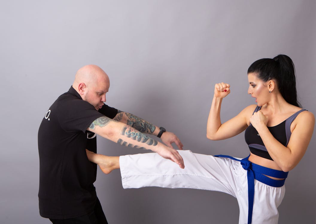 Karateka hitting tattooed male partner during fight