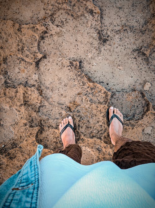 Person Standing on Brown Rock