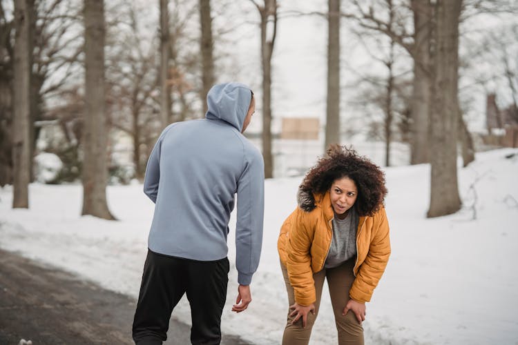 Exhausted Black Woman Resting After Running With Trainer