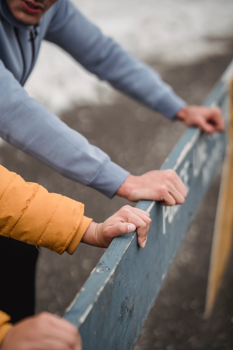 Crop Couple With Wooden Barrier Training On Winter Street