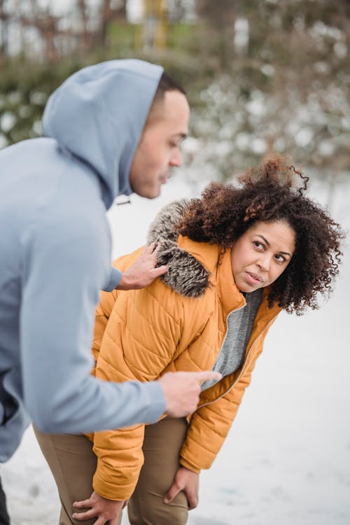 Black trainer with African American female in winter park