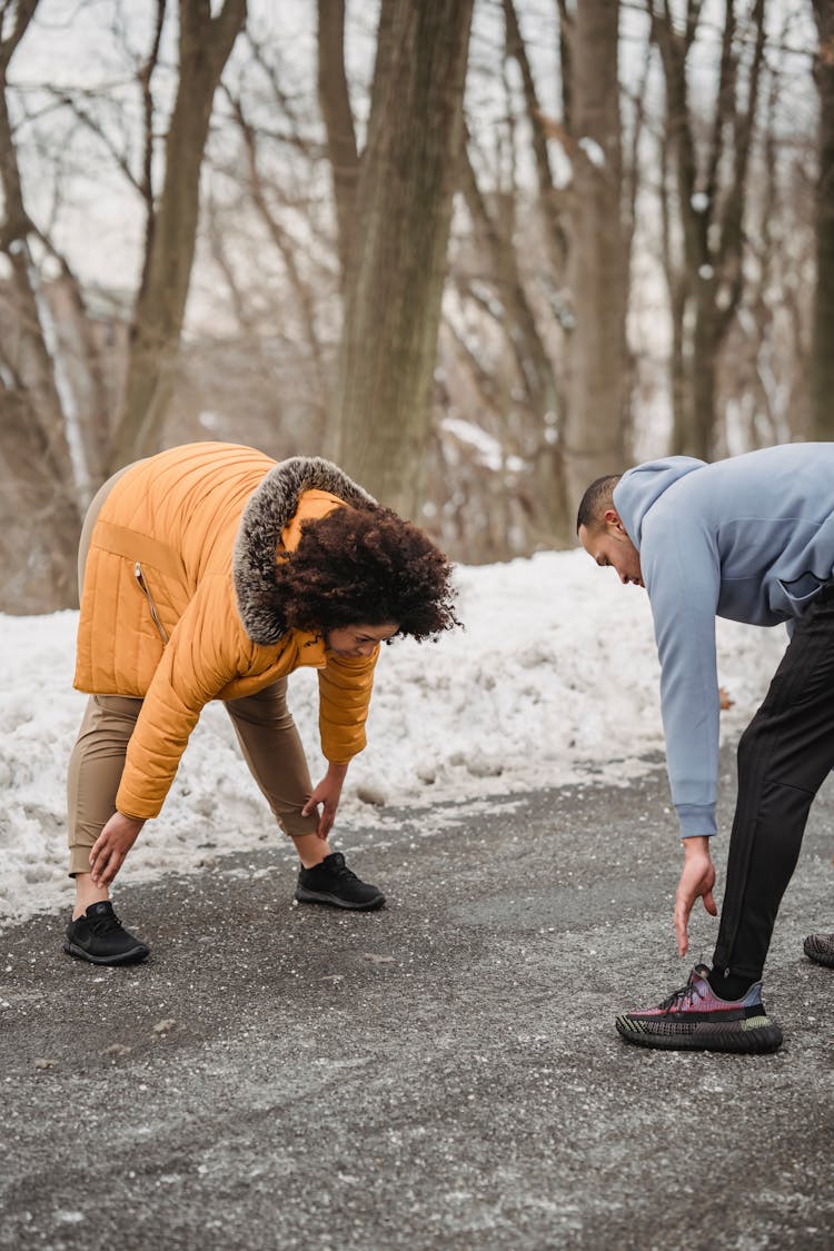 Black Couple Stretching In Winter Park