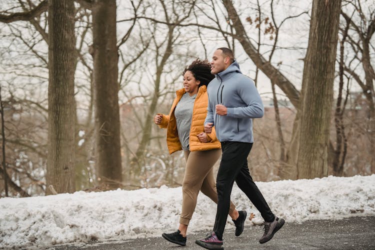 Content Black Couple Jogging On Walkway During Training