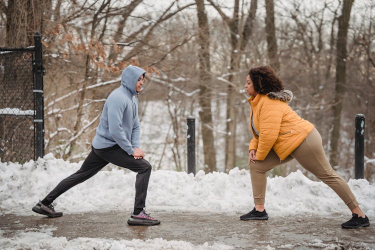 Black Couple Warming Up During Training In Winter Time