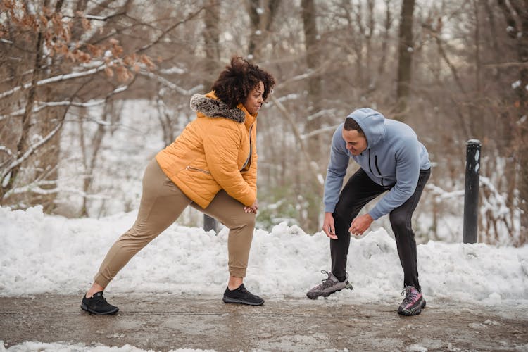 Young Trainer Controlling Black Woman In Doing Lunges