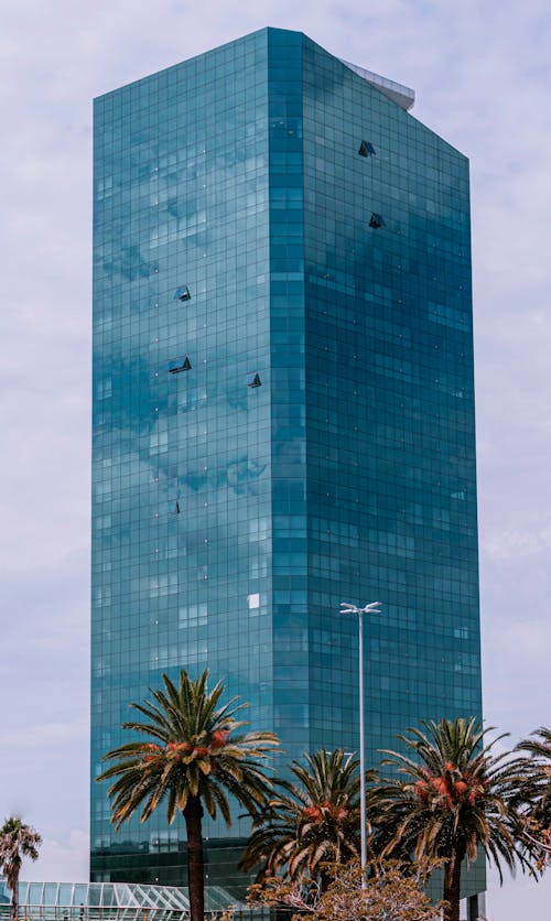 A High Rise Building With Green Glass Windows