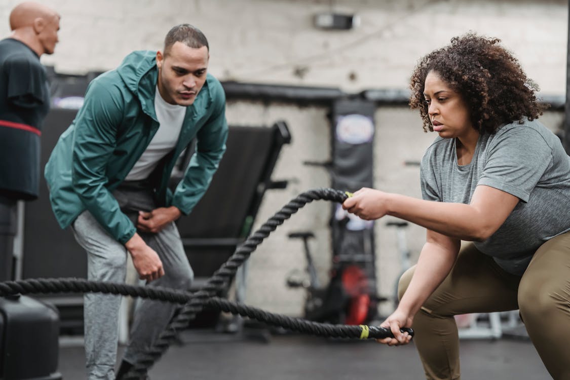 Woman working out with the help of a personal trainer