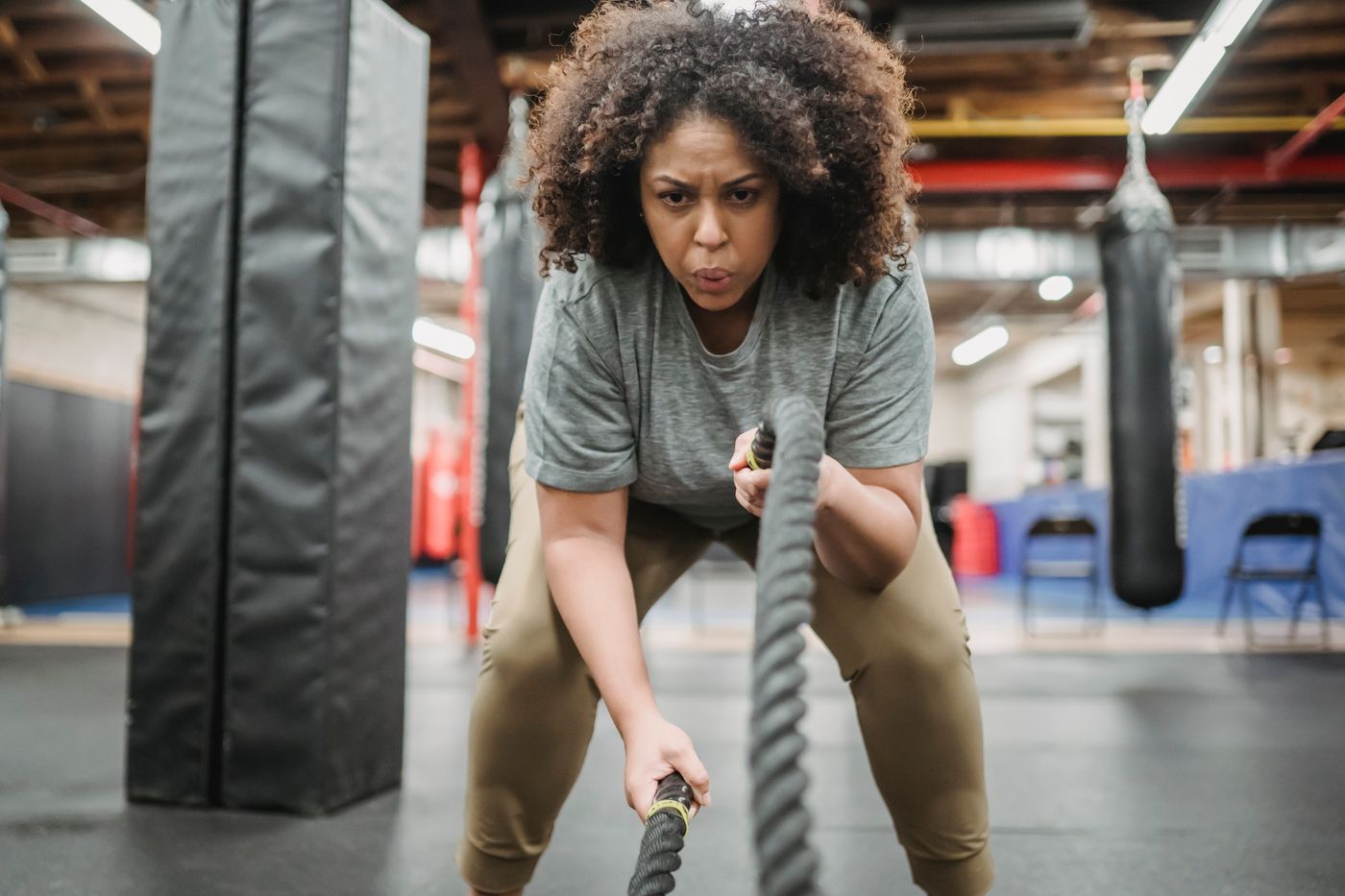 Athlete in activewear doing a battle rope functional training workout, the conditioning zone