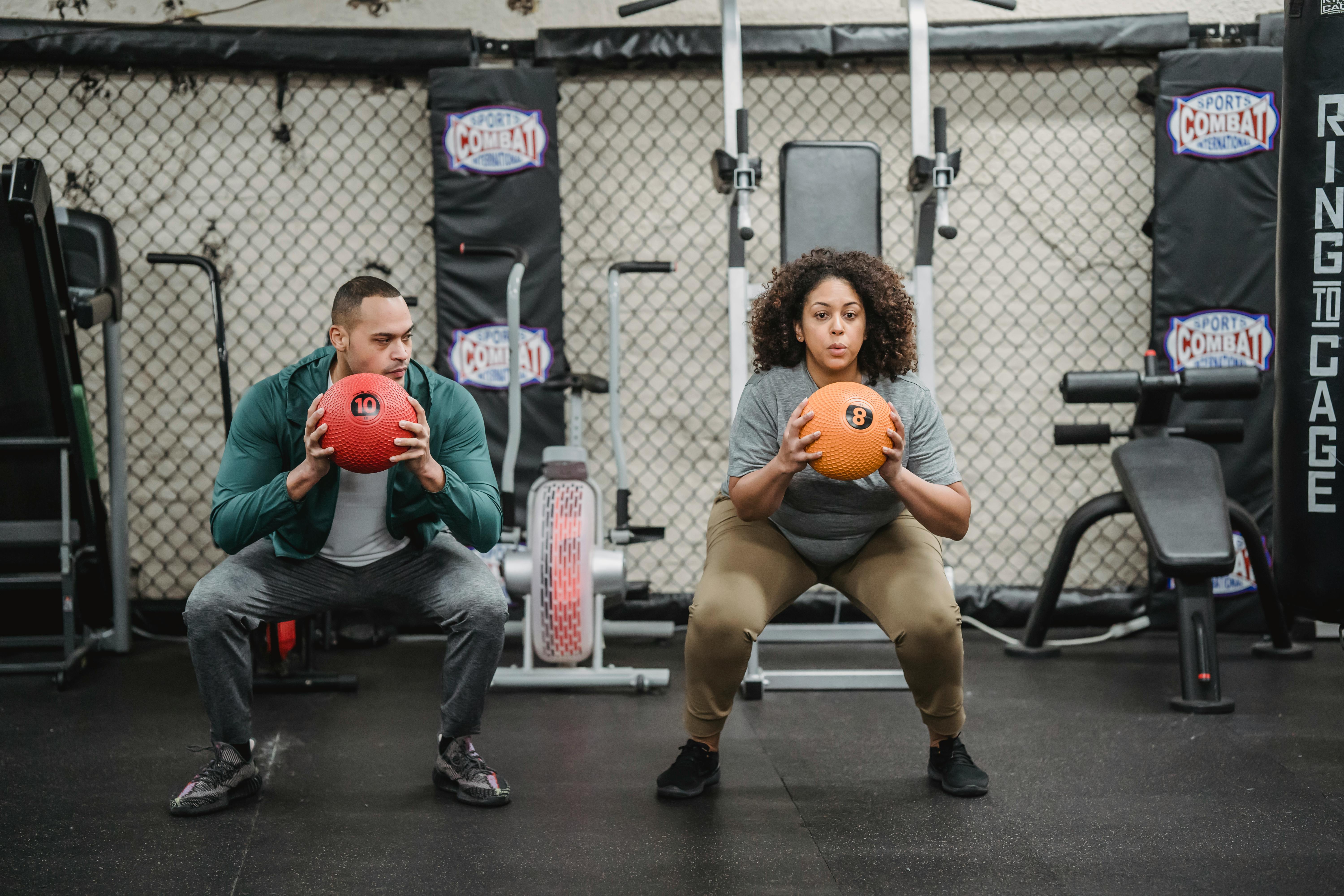 serious multiethnic athletes doing butt exercise in gym