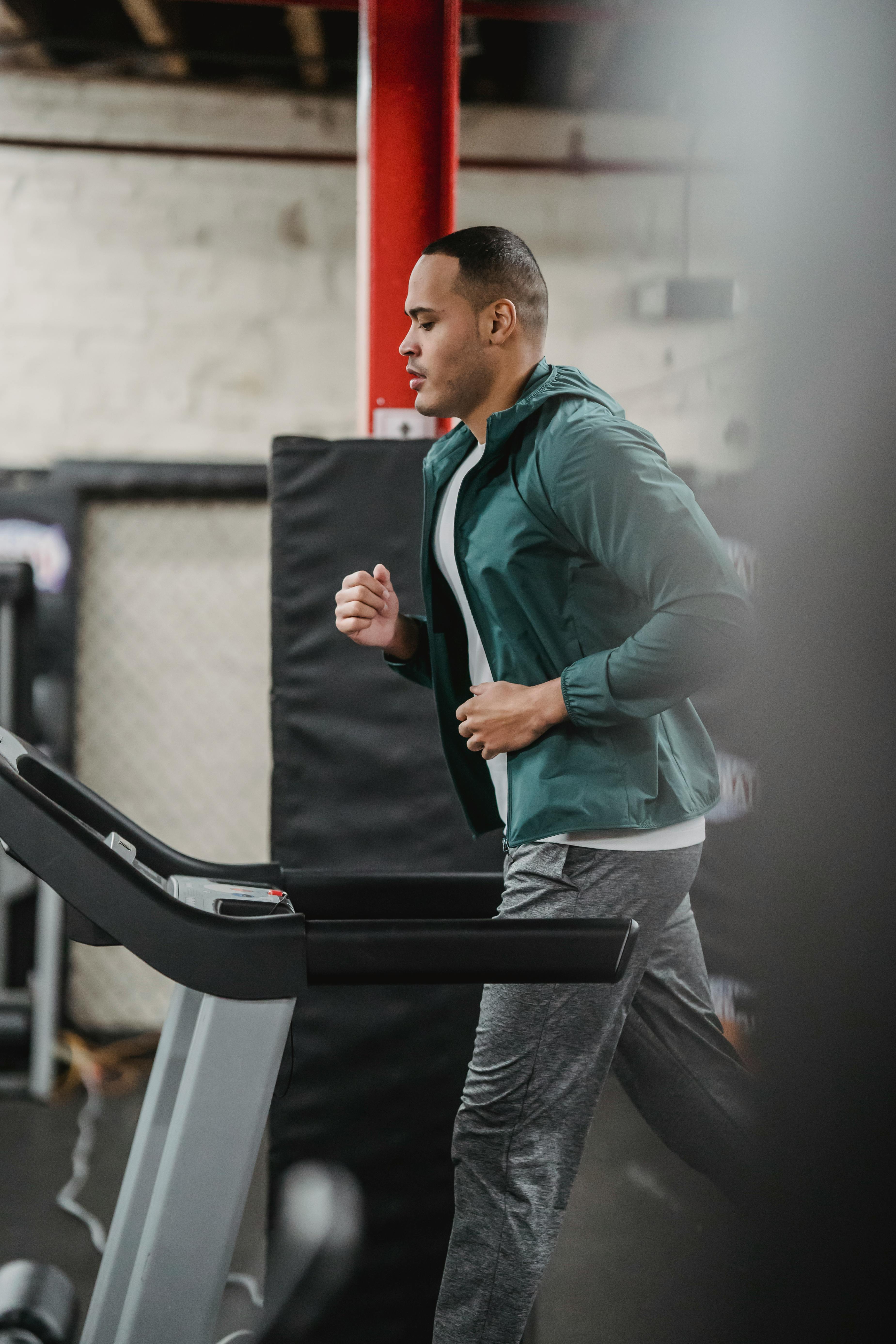 strong man running on treadmill in gym