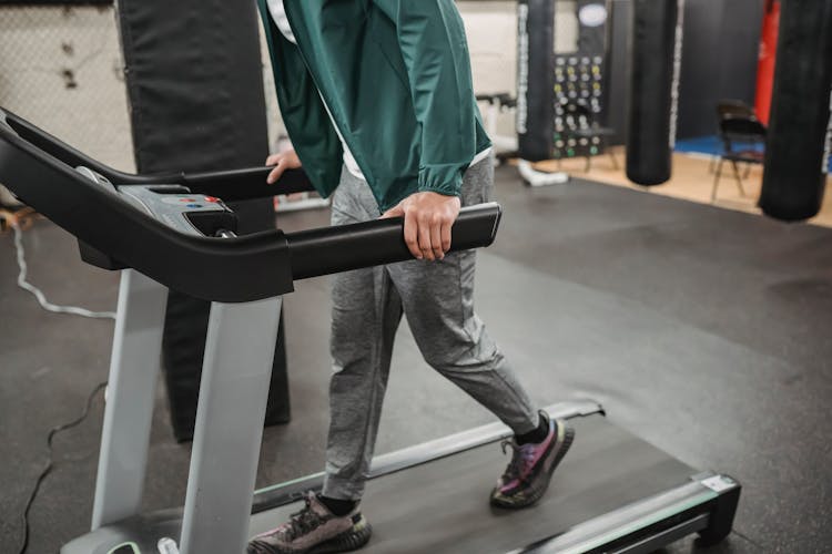 Man Walking On Treadmill In Gym