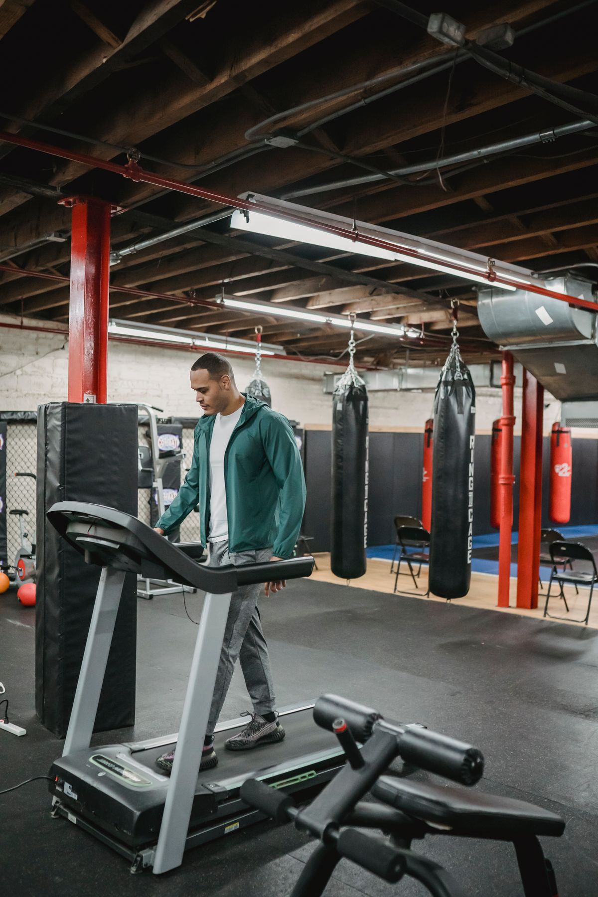 Athlete walking on a treadmill in a spacious fitness gym