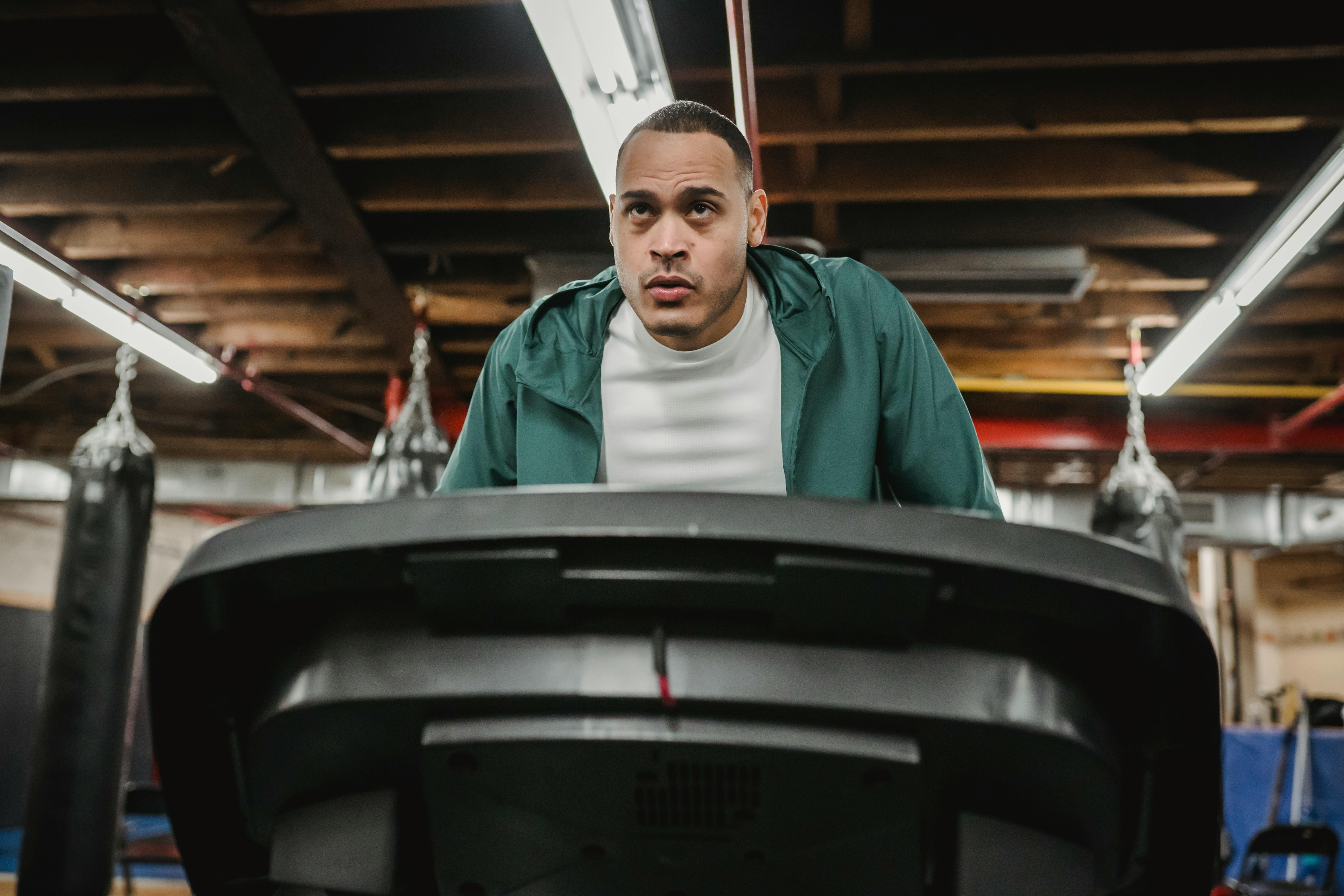 serious sporty man exercising on treadmill