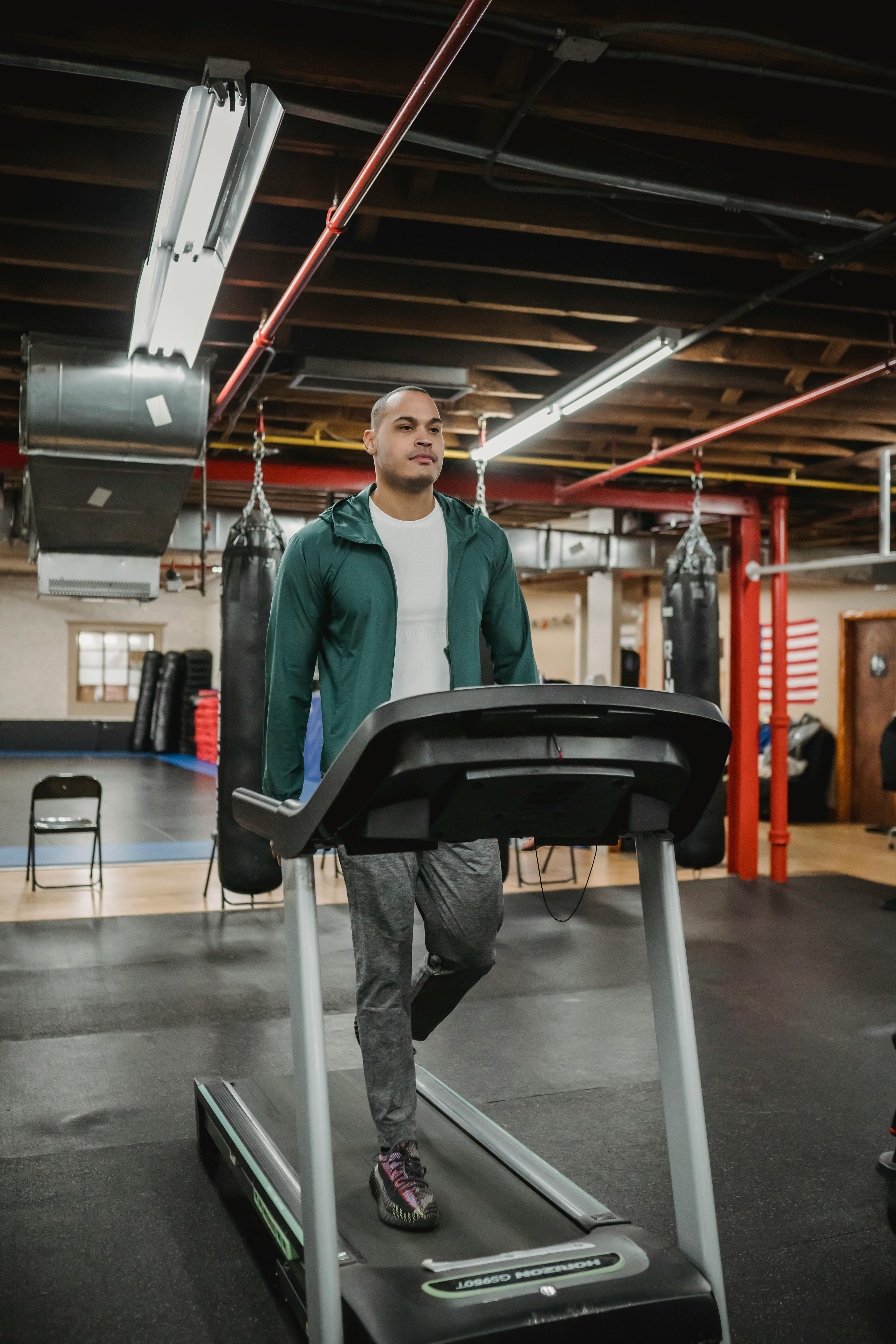 athletic professional trainer walking on treadmill