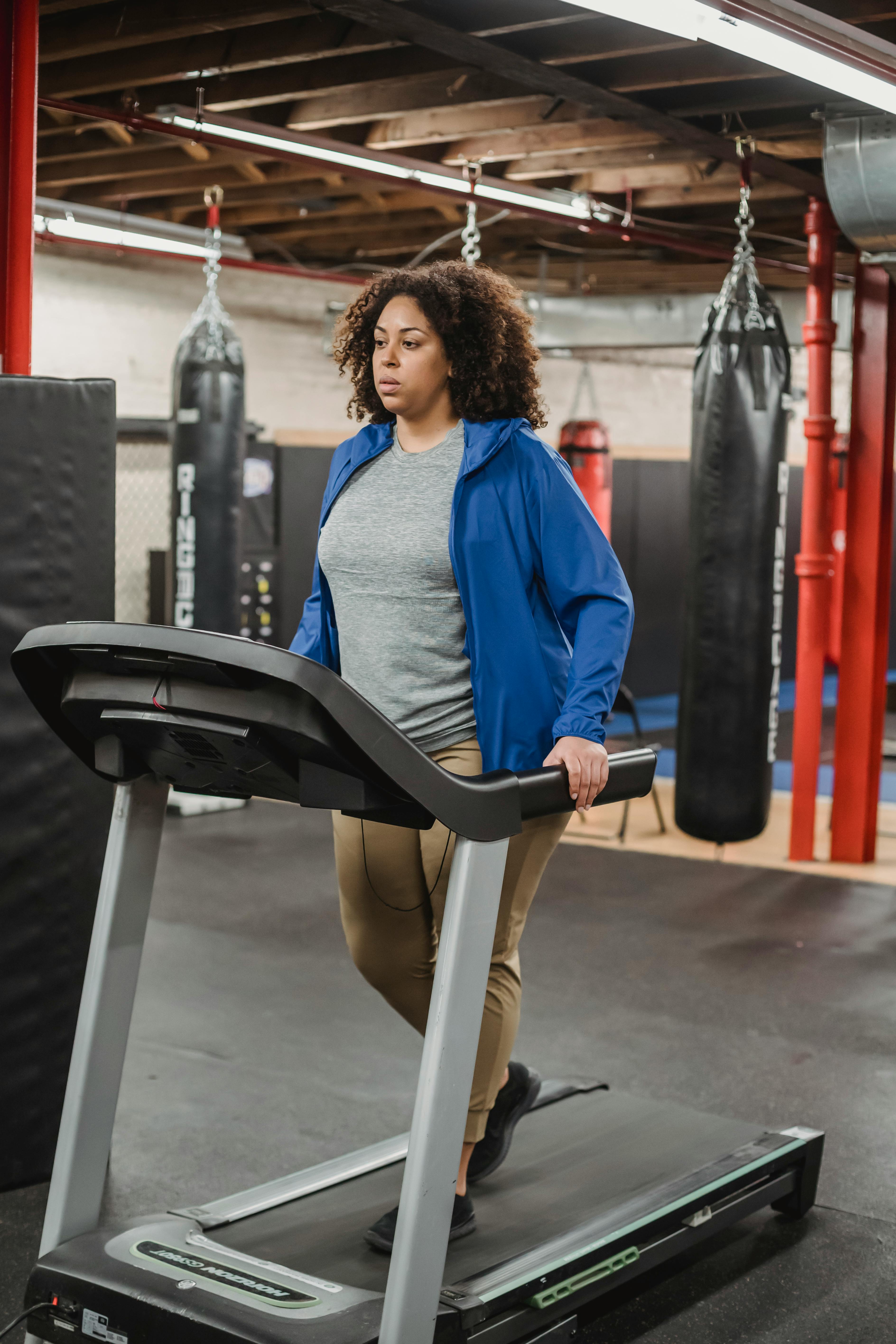 black woman standing on treadmill during cardio workout