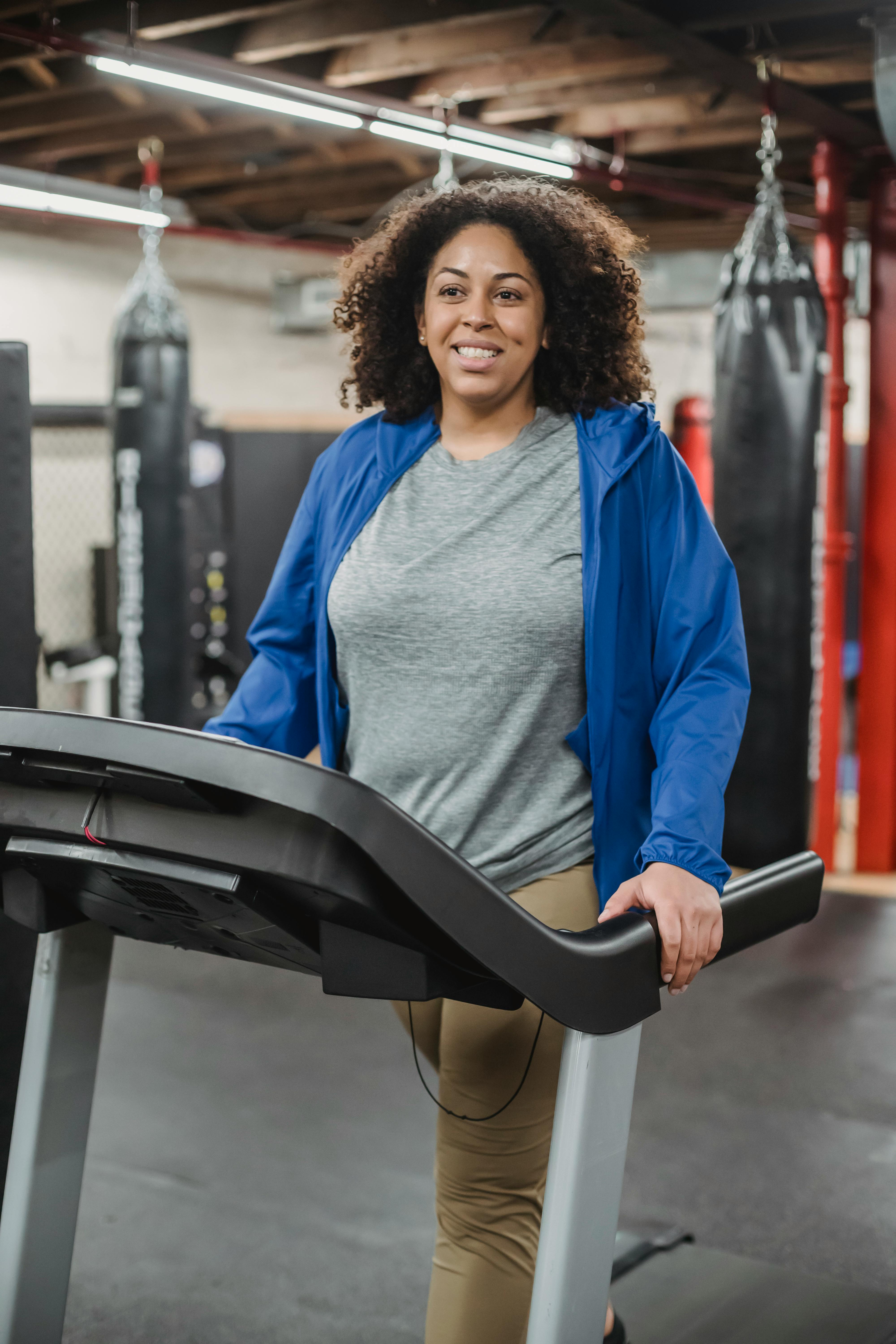 smiling woman on treadmill in gym