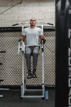 Full body of serious African American sportsman doing abdomen exercises for strengthen muscles in gym