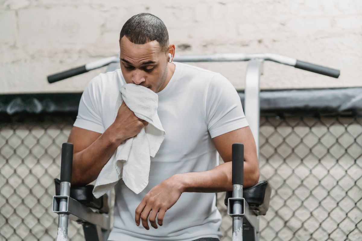 Black athlete resting after intense high-intensity interval training session