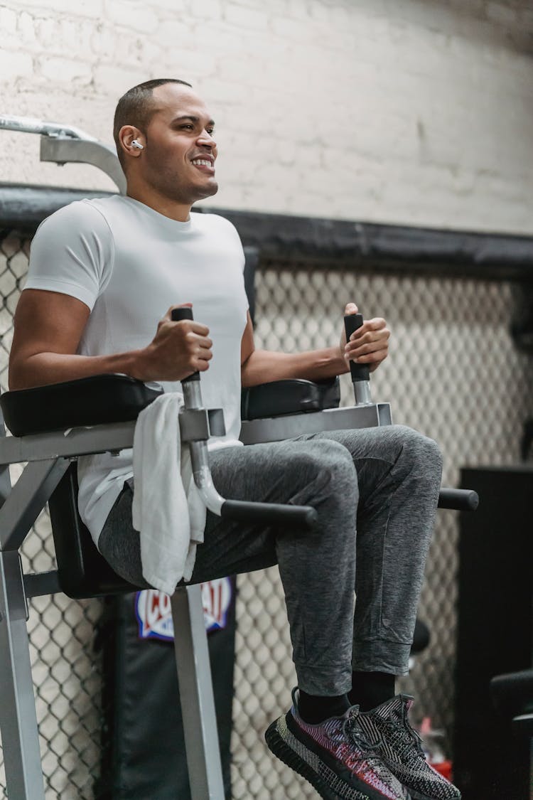 Black Sportsman Doing Abs Exercises On Machine