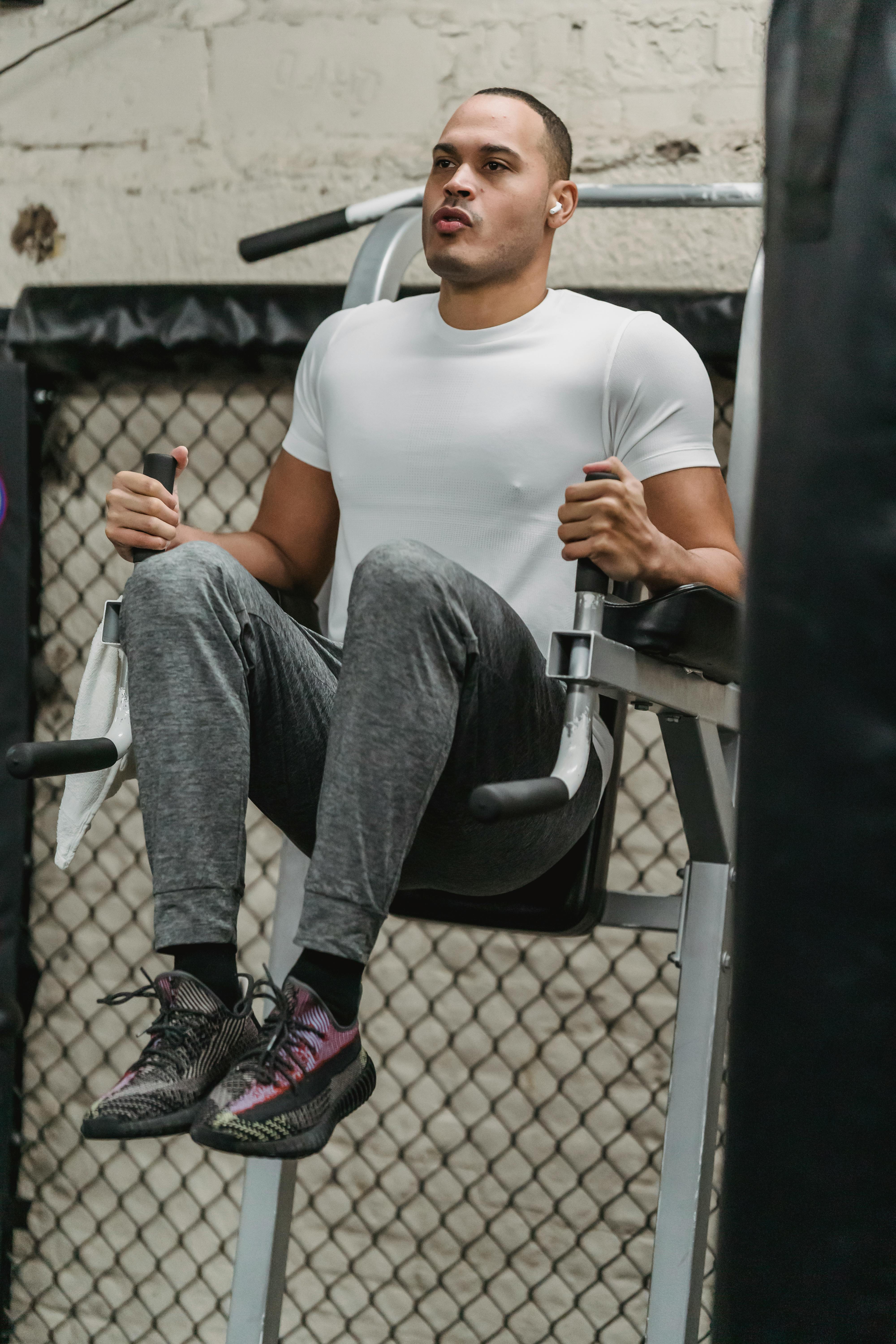 serious young man working out muscle in gym