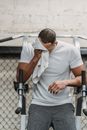 Young black athlete wiping face with towel