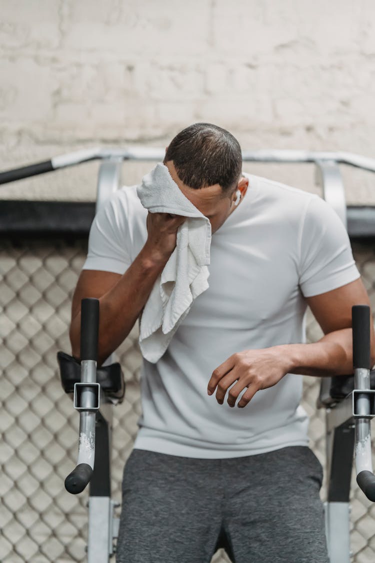 Young Black Athlete Wiping Face With Towel