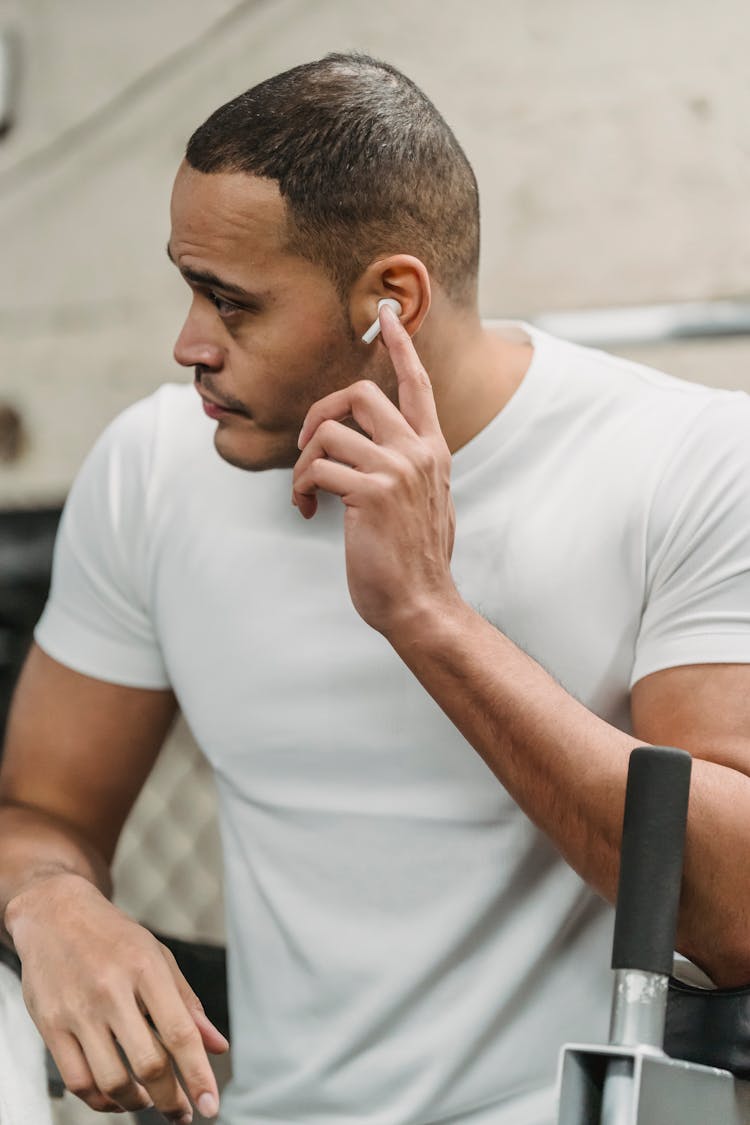 Serious Young Man Listening To Music In Gym