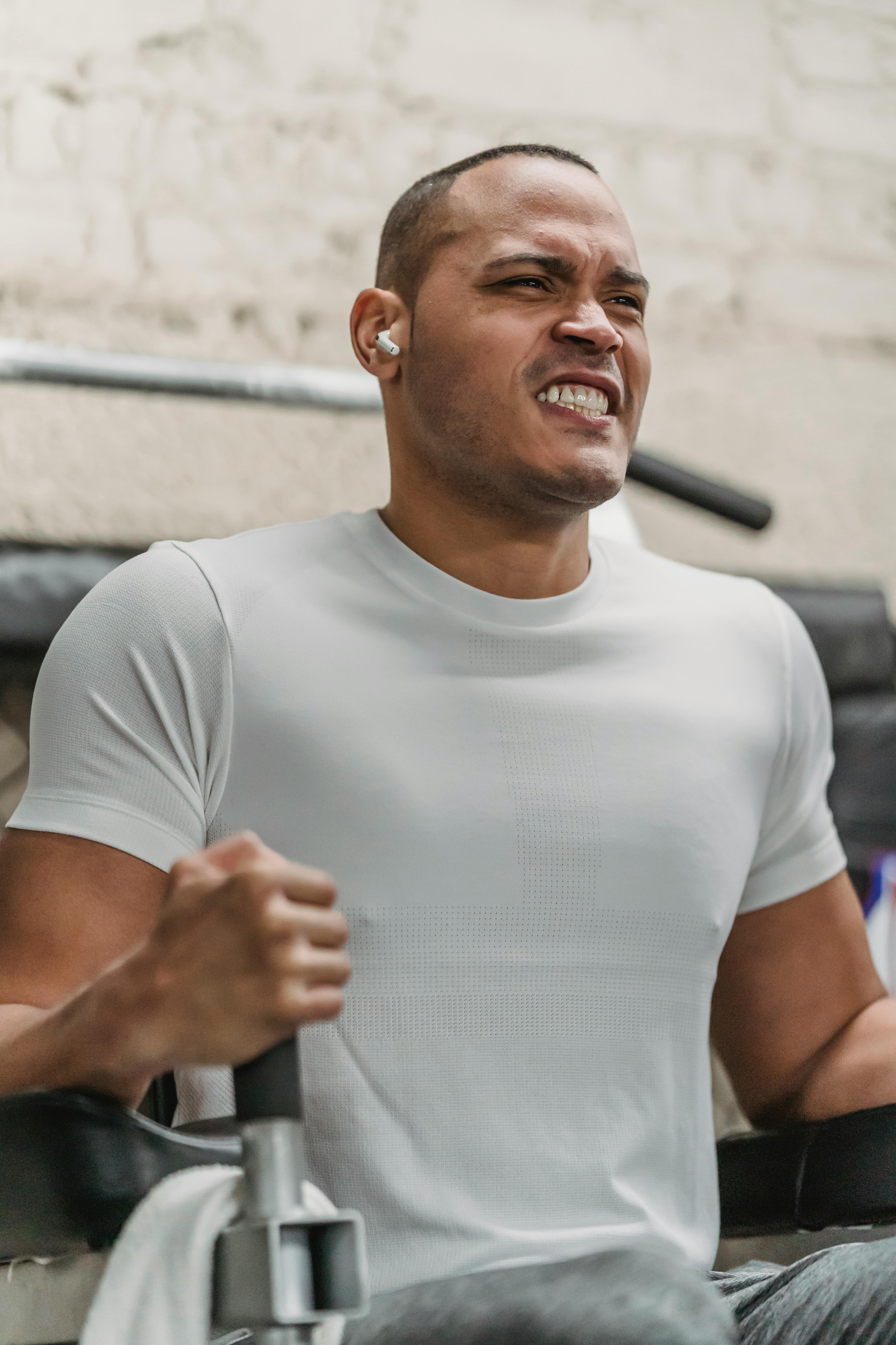 black athlete with tense face training in gym