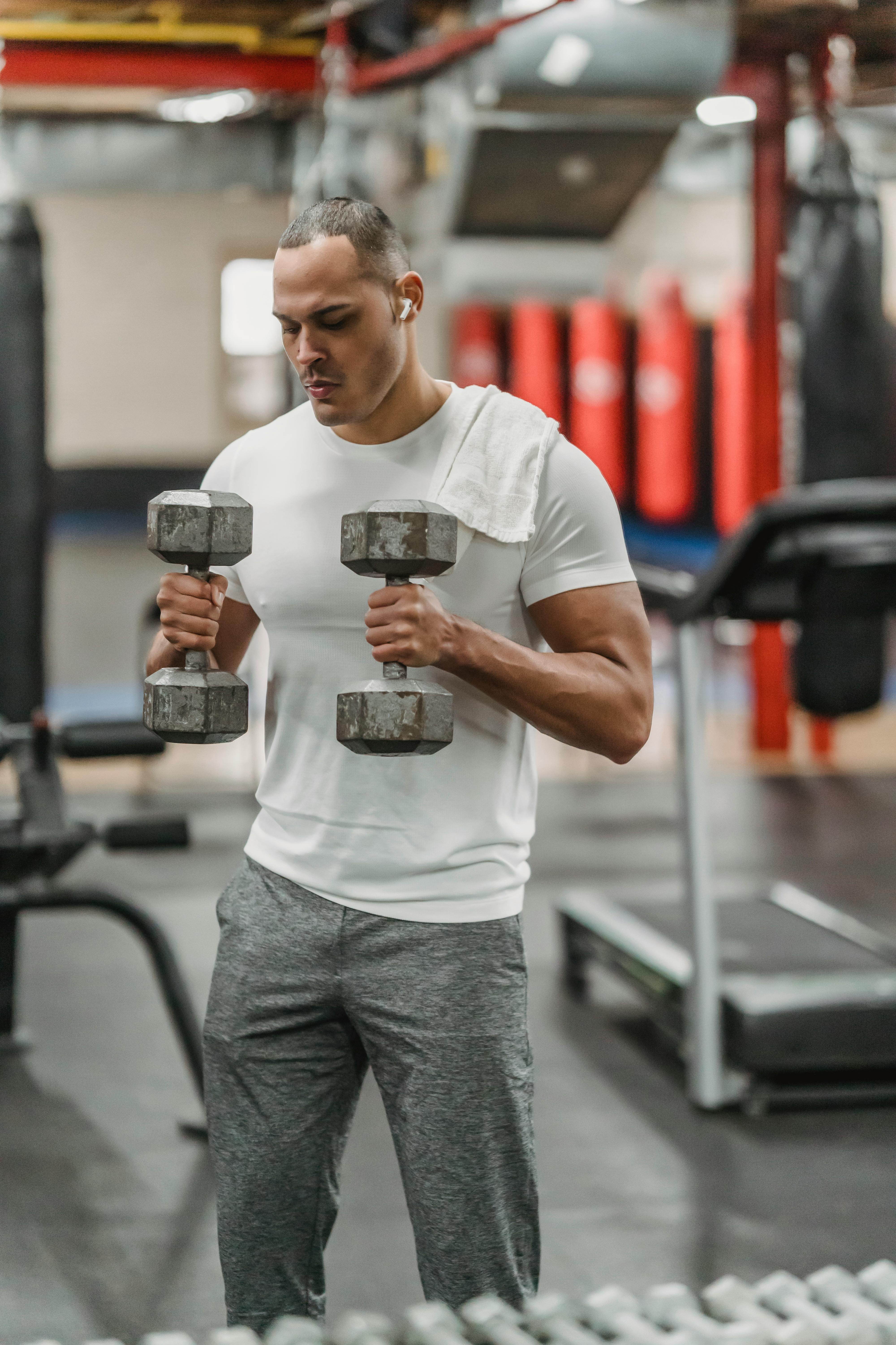 strong man exercising with heavy dumbbells