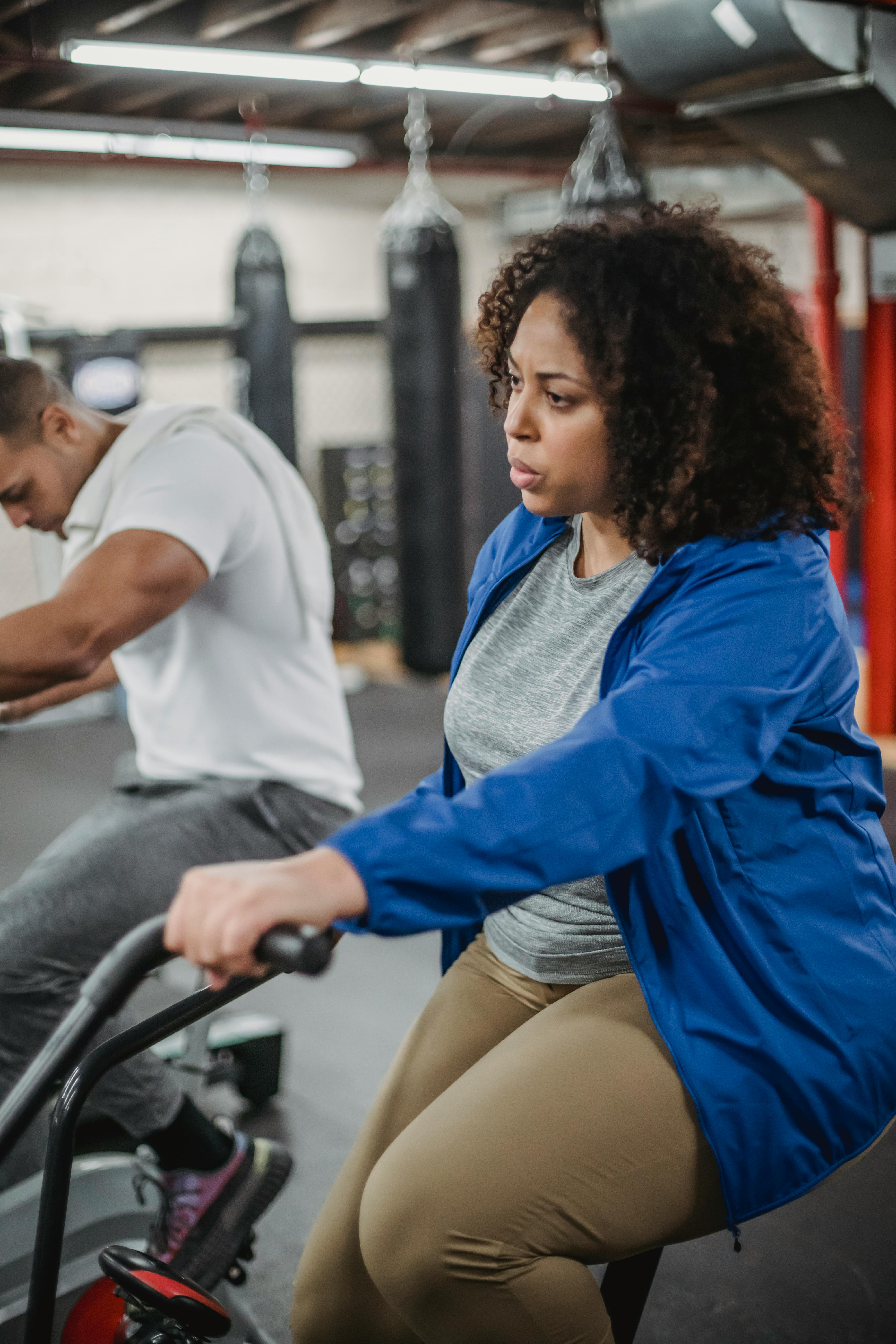 black woman exercising on cycling machine