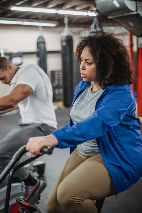 Black woman exercising on cycling machine