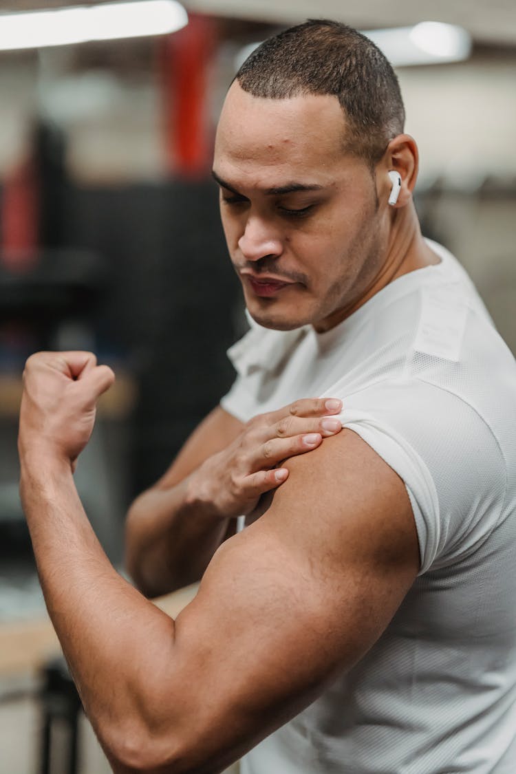 Muscular Sportsman Doing Exercises In Gym