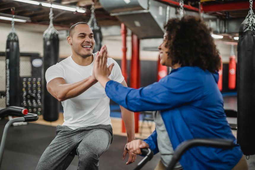 Two training partners celebrating a set together — photo by Julia Larson on Pexels