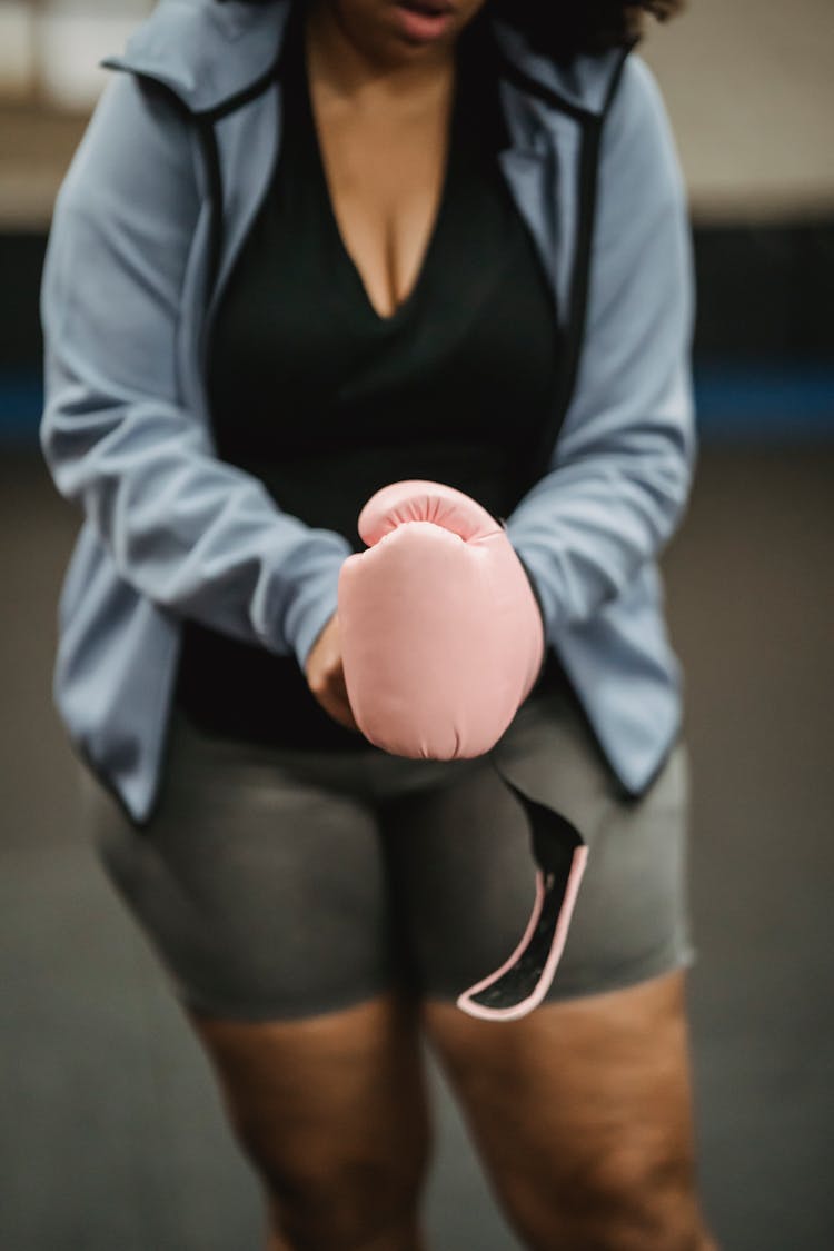 Crop Unrecognizable Black Woman Putting On Boxing Glove