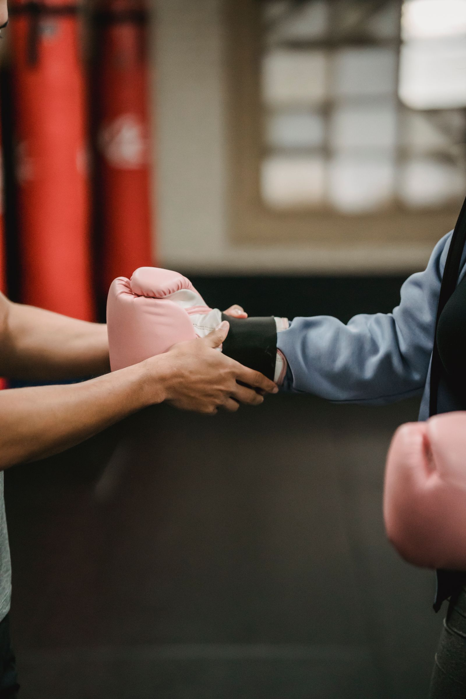 Physiotherapist assisting a person with knee support during rehabilitation exercise