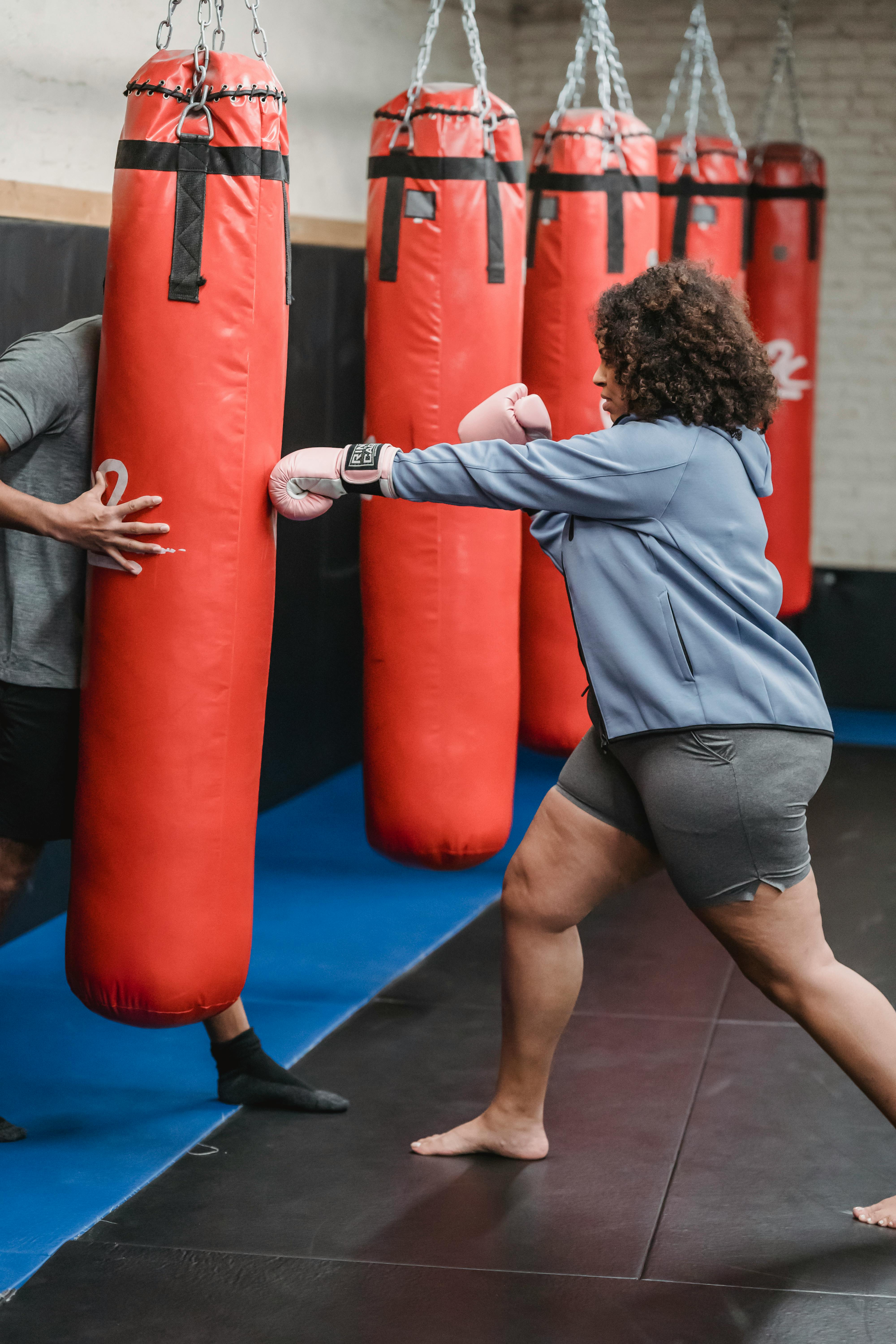Premium Photo  Girl punching sandbag muaythai boxing training healthy girl  punching at boxing bag