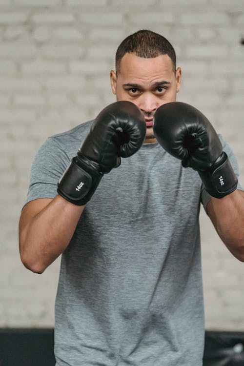 Ethnic boxer showing defense technique during workout
