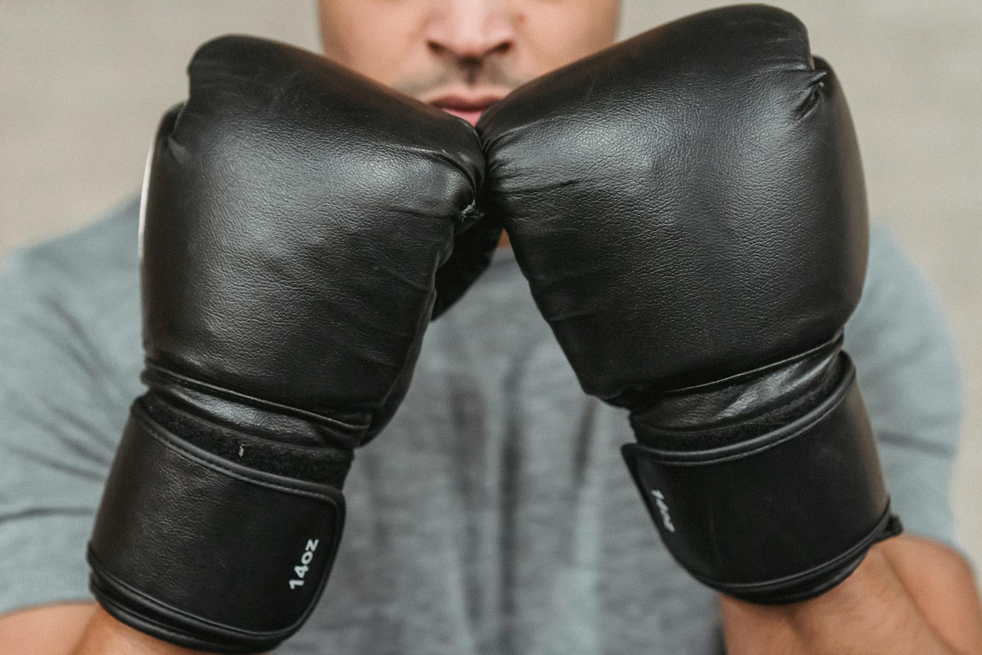 Anonymous male boxer standing in defensive pose