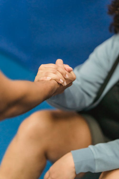 Free Anonymous couch supporting obese woman resting on floor during training in gym Stock Photo