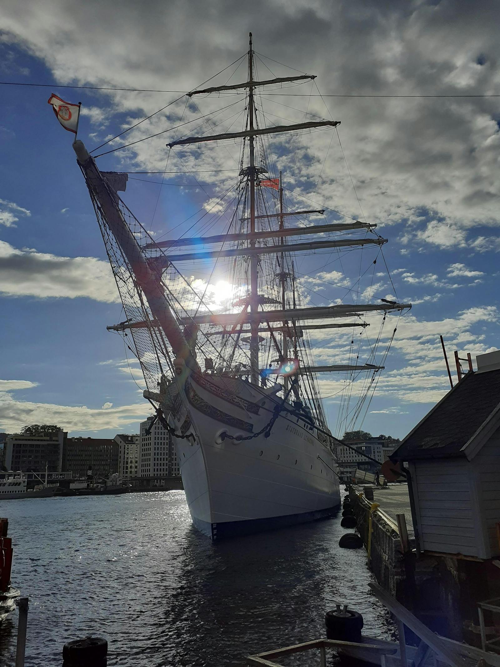 Pro wrestler holding a championship belt in front of arena lights