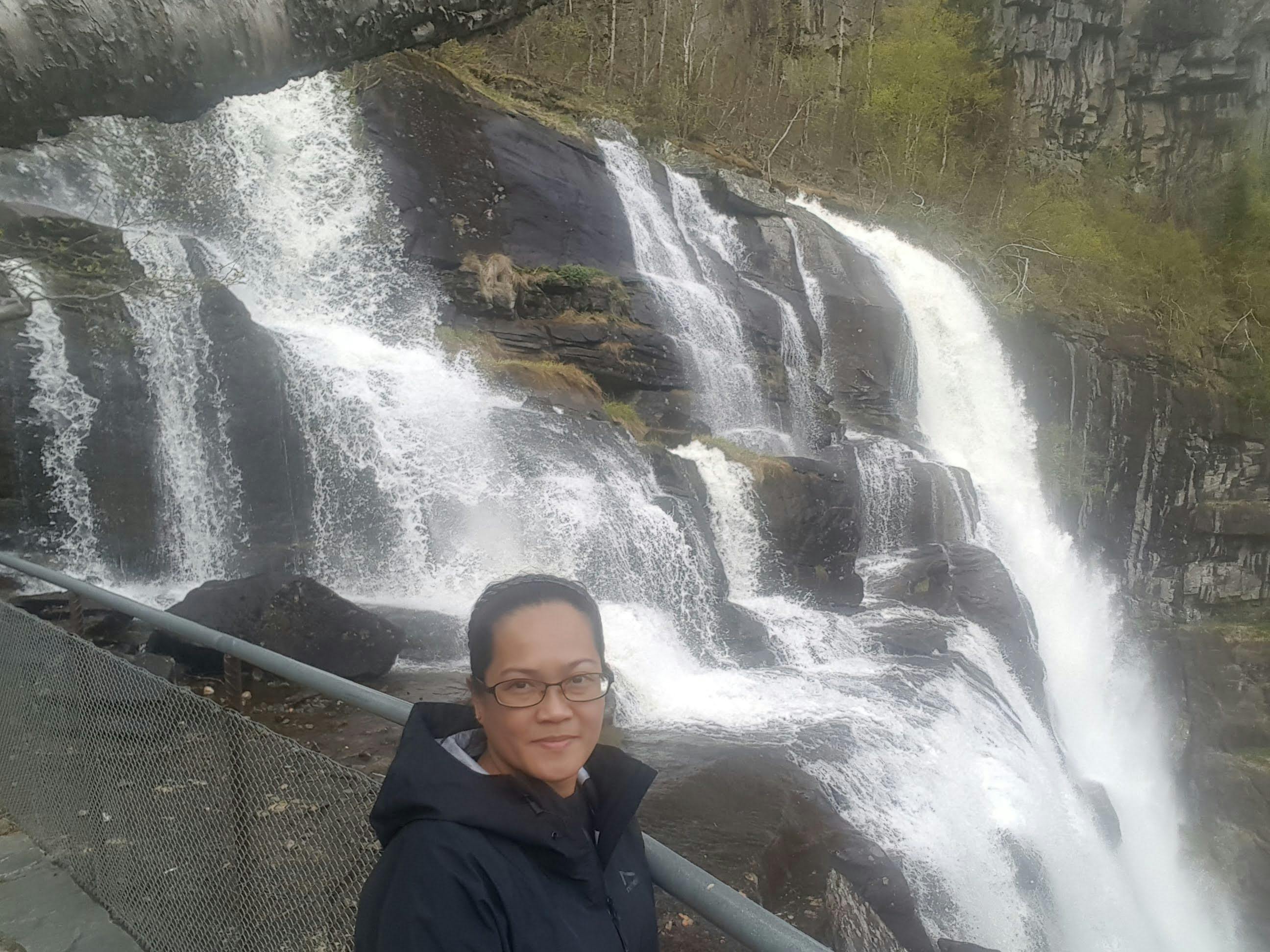 Two professional wrestlers locking up in a ring under bright arena lights