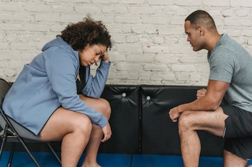 Free Tired black woman with trainer in gym Stock Photo